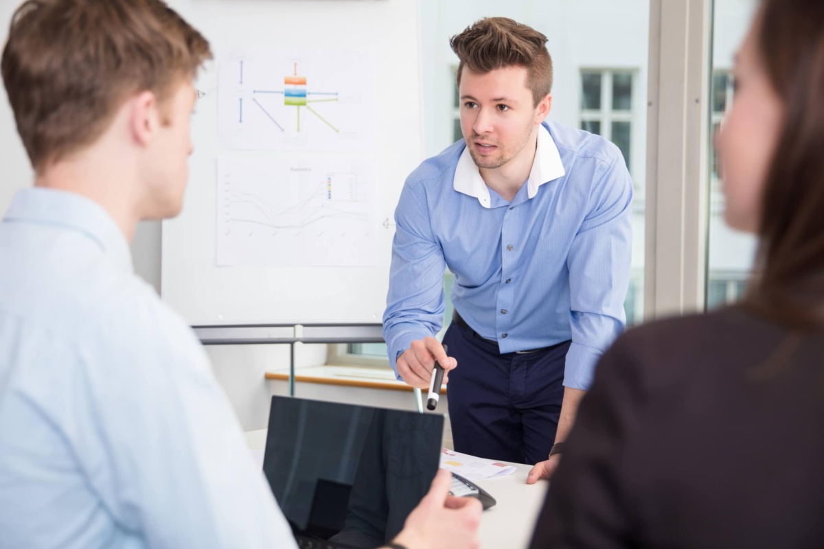 Businessman Communicating With Colleagues In Meeting at Office