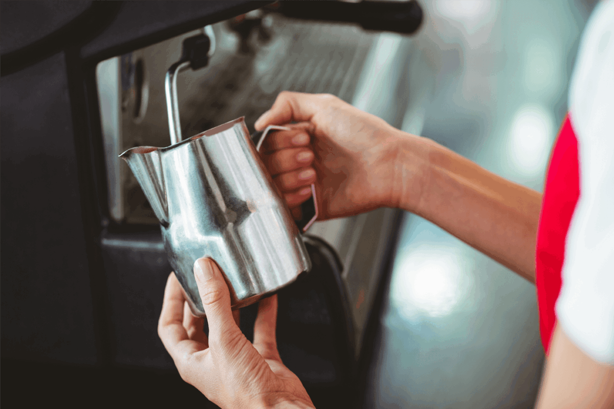 Barista steaming milk