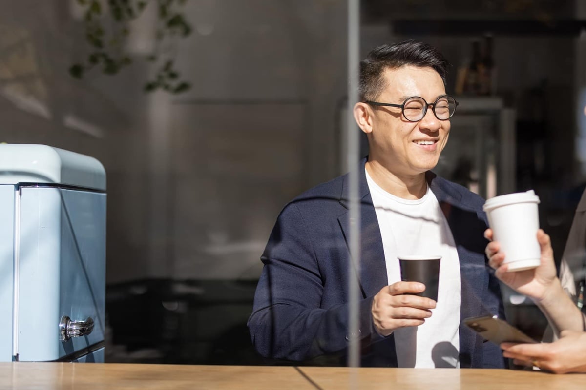 Two people enjoying coffee in a kitchen area