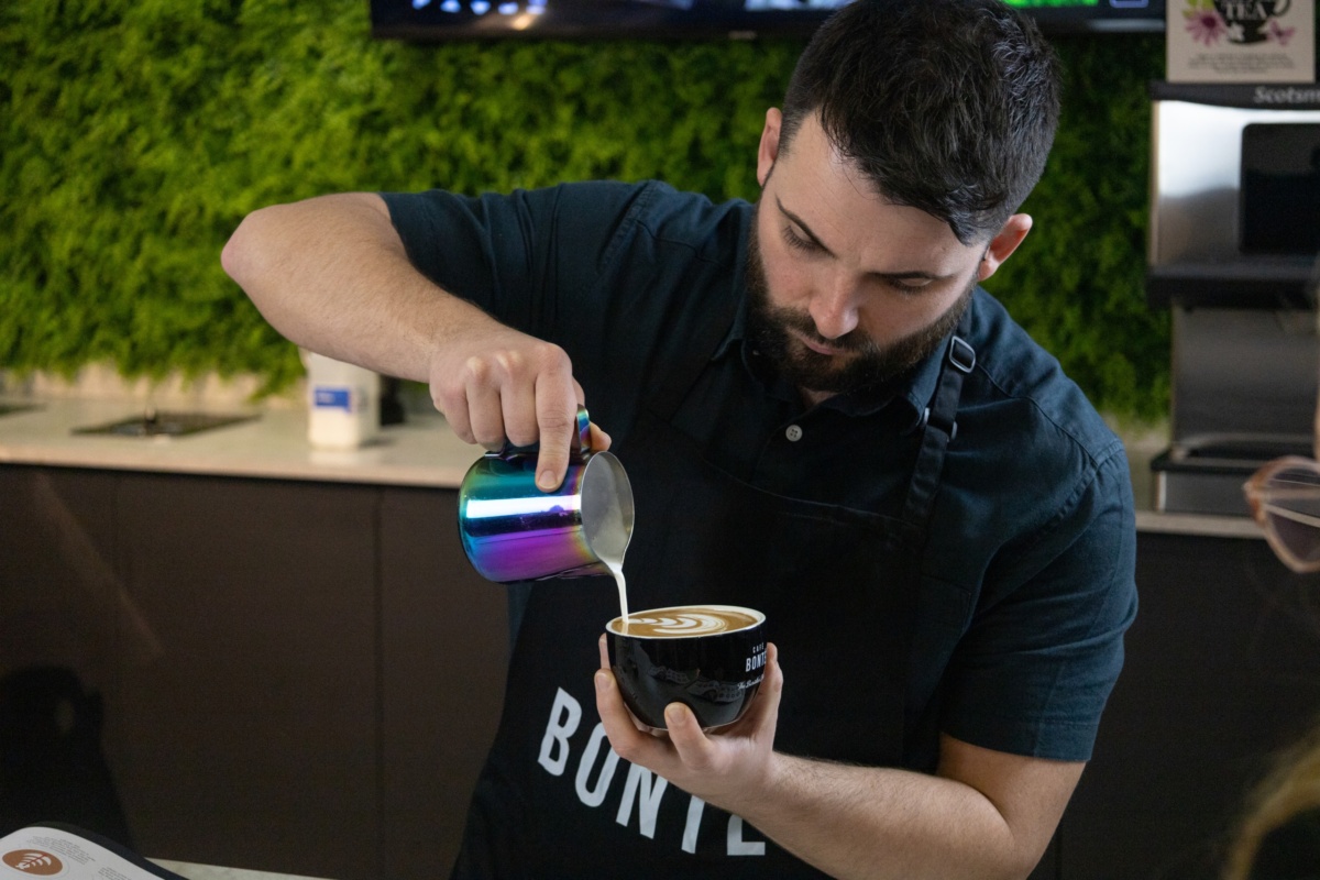 Tim creating coffee art in a coffee mug