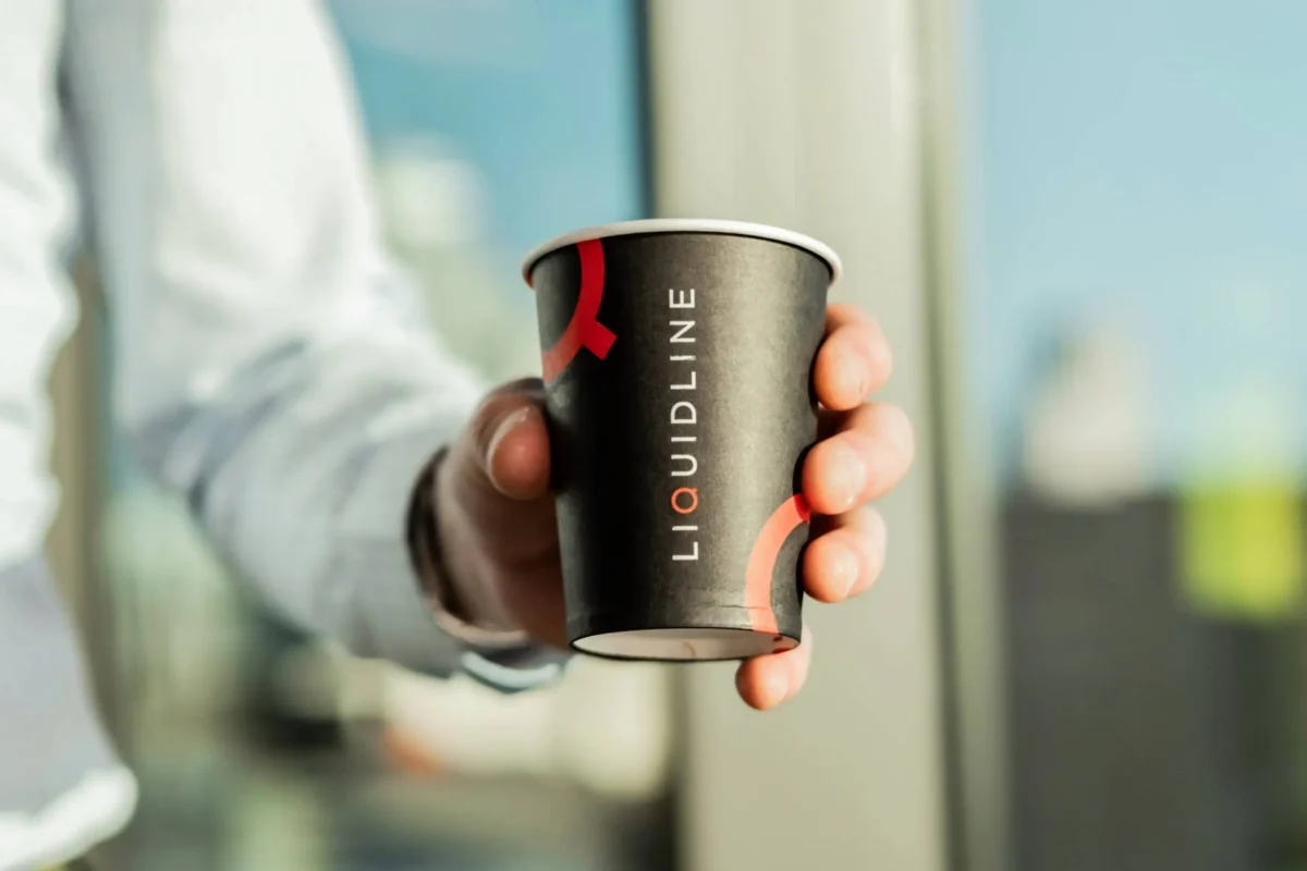 Liquidline paper coffee cup in hand