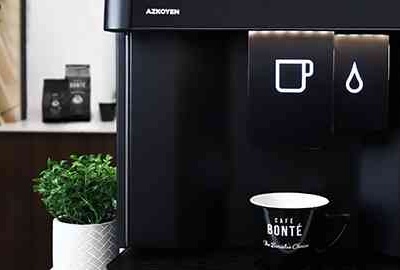 Liquidline Q3 coffee machine with a cafe bonte coffee cup and plant next to the machine