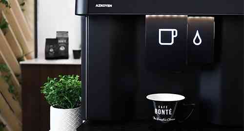 Liquidline Q3 coffee machine with a cafe bonte coffee cup and plant next to the machine