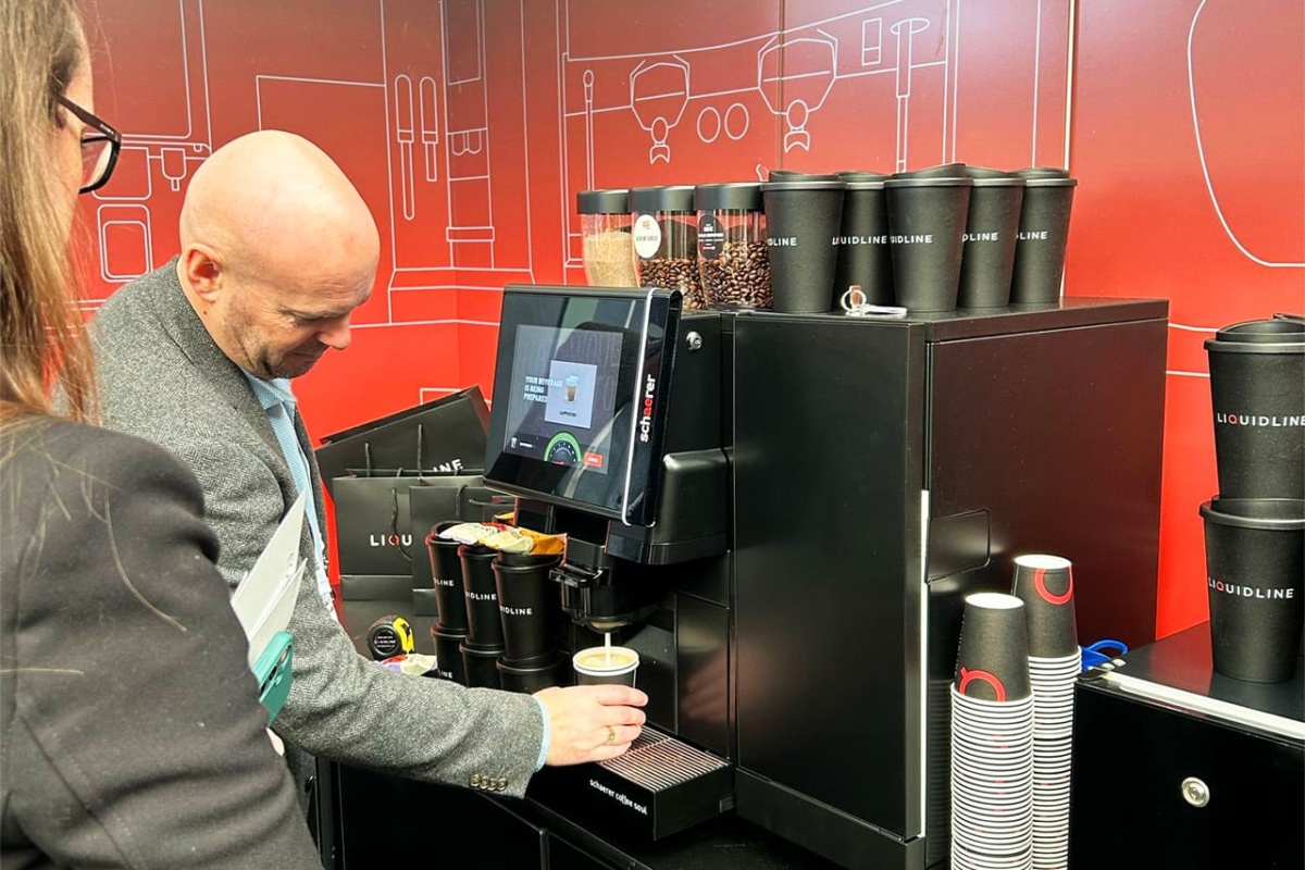 Liquidline exhibition stand with staff demoing machine