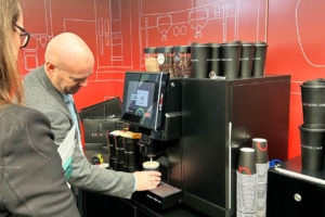 Liquidline exhibition stand with staff demoing machine