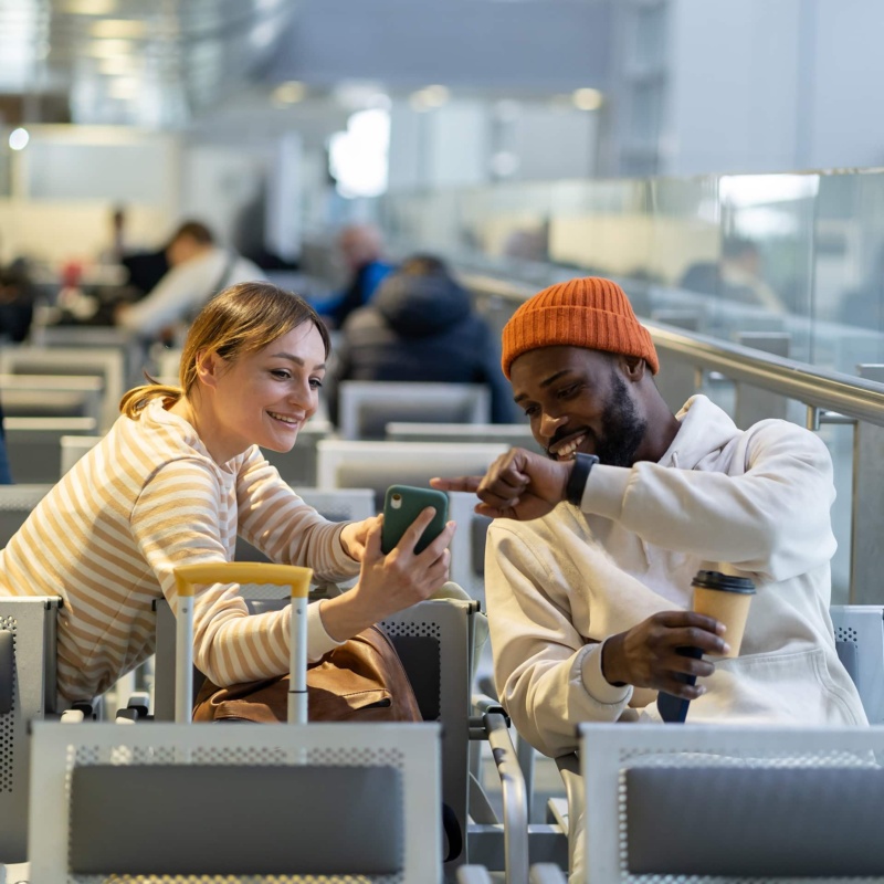 Couple waiting at airport enjoying coffee