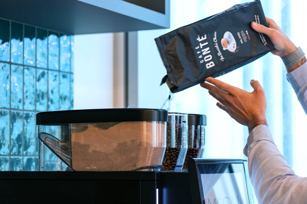 filling a coffee machine bean hopper with coffee beans