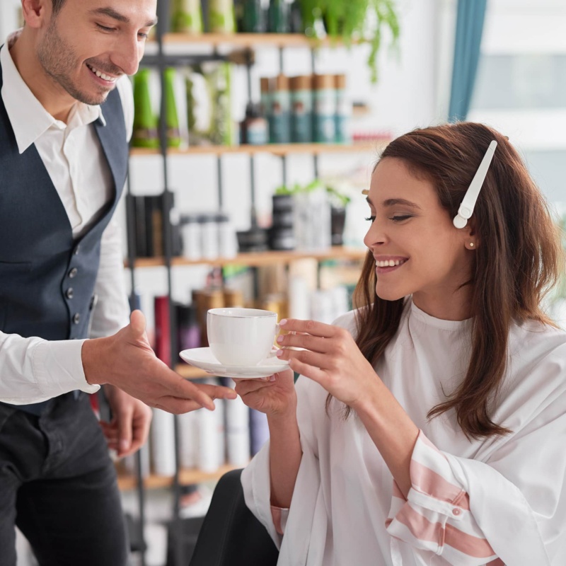 Women being served coffee in retail environment