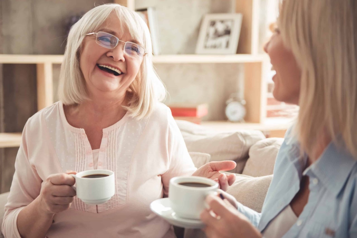 Women in care home enjoying coffee