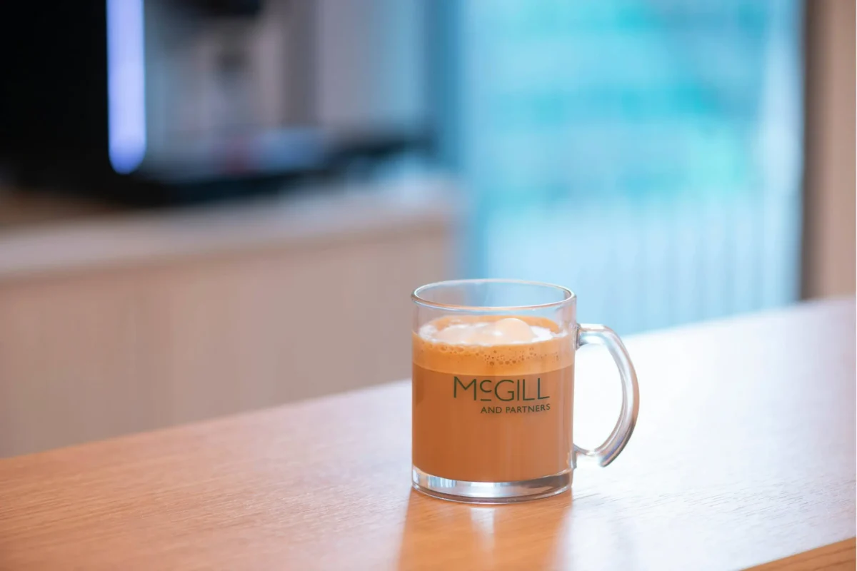 McGill and Partners branded coffee cup