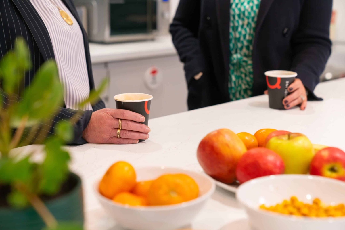Paper takeaway coffee cups being held