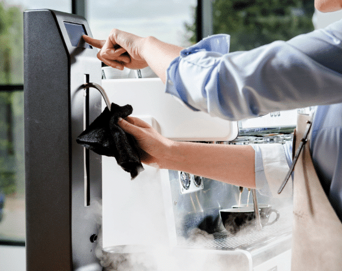 Barista cleaning a Perfect Moose Jack Milk Steamer
