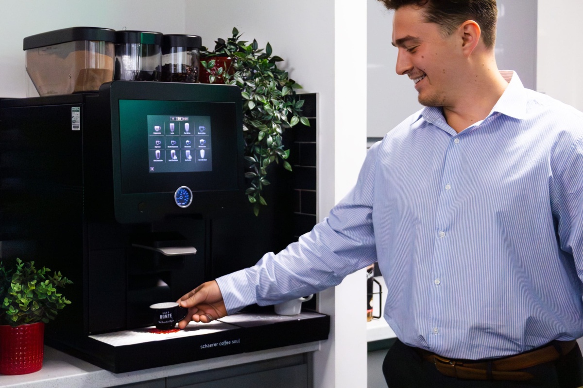 person using a schaerer coffee machine