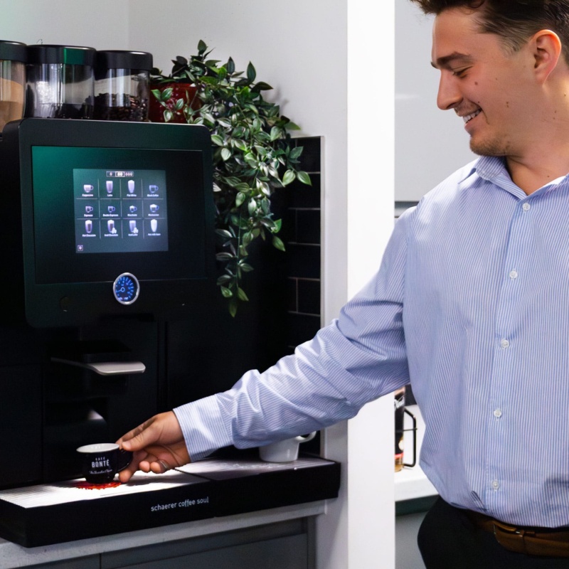 person using a schaerer coffee machine