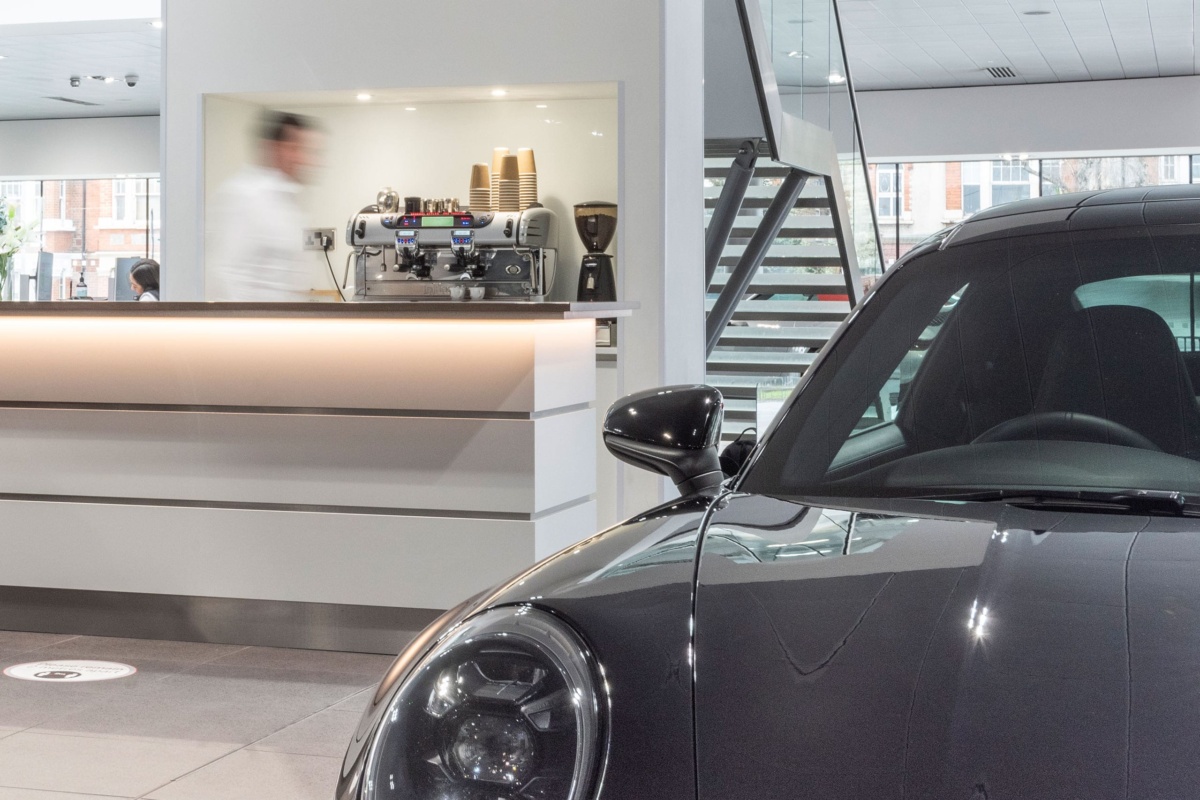 traditional espresso machine in car showroom