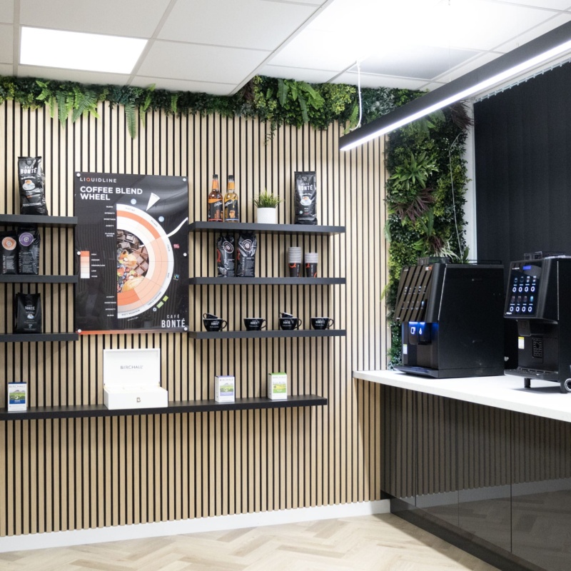 image if a wall with coffee cups, coffee bean bags and coffee syrups on selves