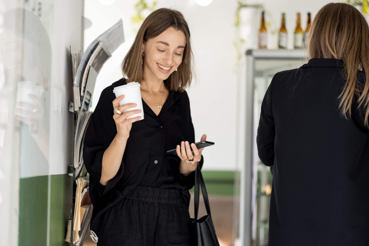 Woman with coffee to go in retail setting