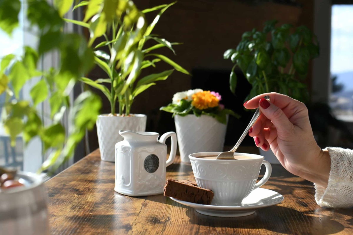 Stirring coffee in garden centre