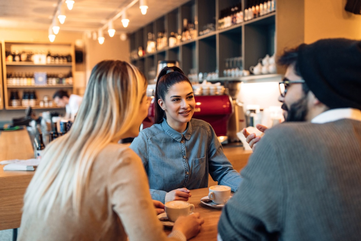 Three people enjoying coffee in restaurant