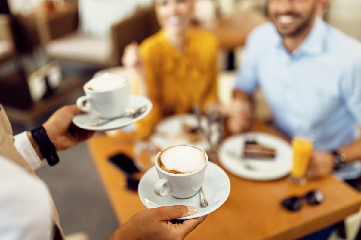 Waitress holding coffee cups