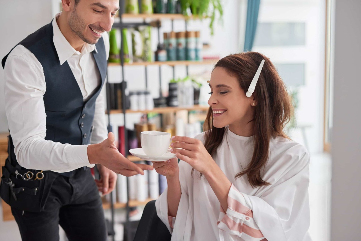 Woman being served coffee in retail setting