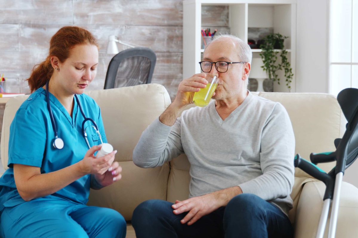 Nurse with patient drinking juice