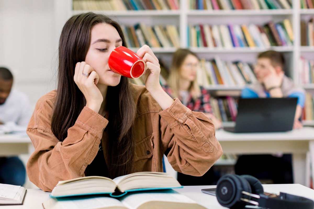 Student drinking coffee from cup