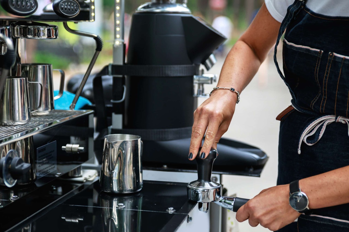 barista tamping coffee