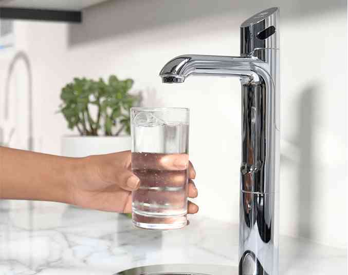Zip HydroTap G5 Touch Free Wave with a glass of cold water