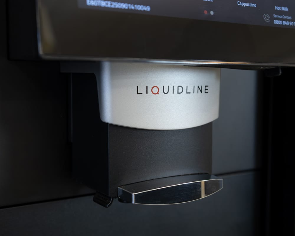 Close‑up of Liquidline K1FM coffee machine dispenser spout.