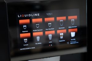 Liquidline K1FM touchscreen coffee machine menu displaying drink options .