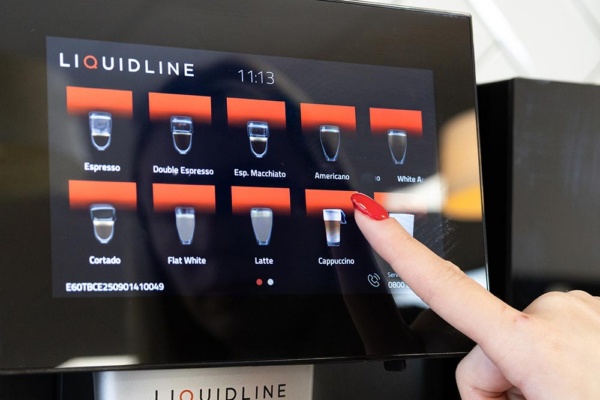 Hand selecting drink on K1 screen