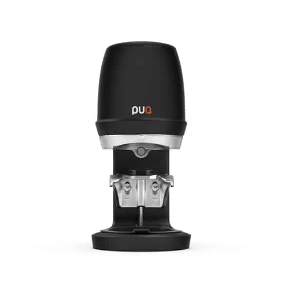 Black PuqPress automatic coffee tamper shown from the front, featuring a compact cylindrical top and a metal tamping mechanism at the base.