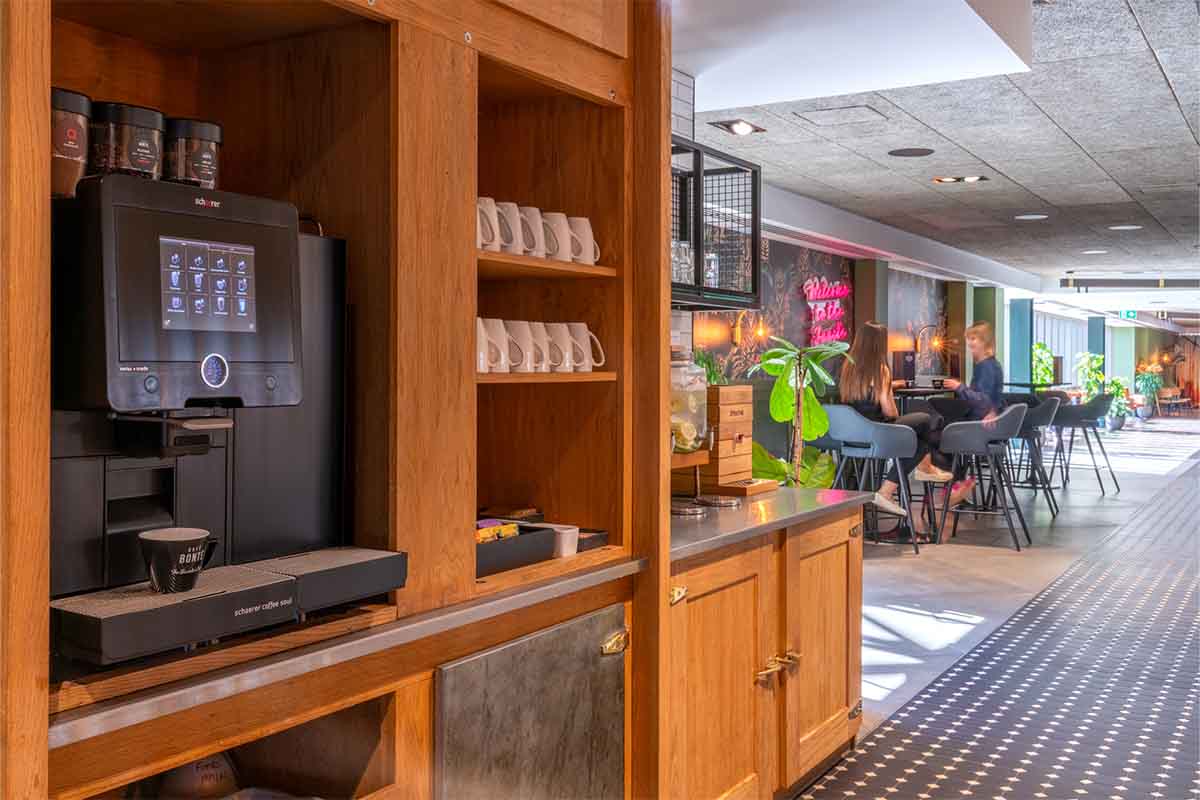 bean to cup coffee machine in place in a kitchenette