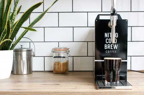 nitro cold brew coffee machine in front of wall