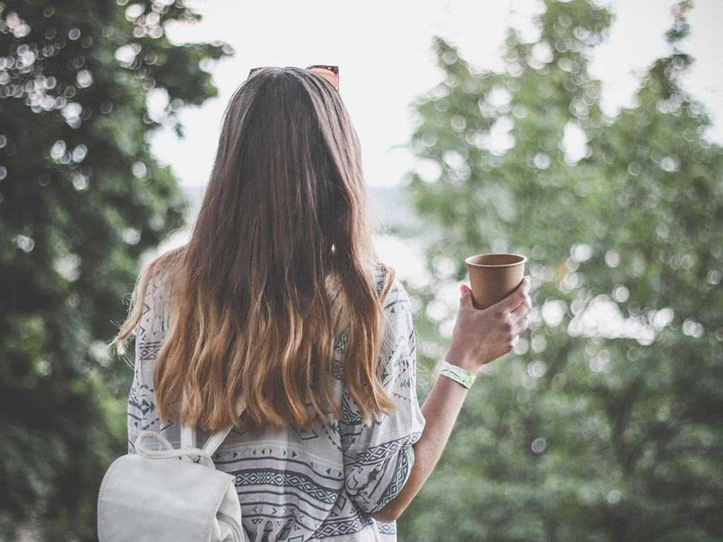 Woman walking with coffee in hand