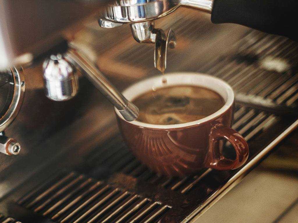 espresso pouring from tradtional coffee machine