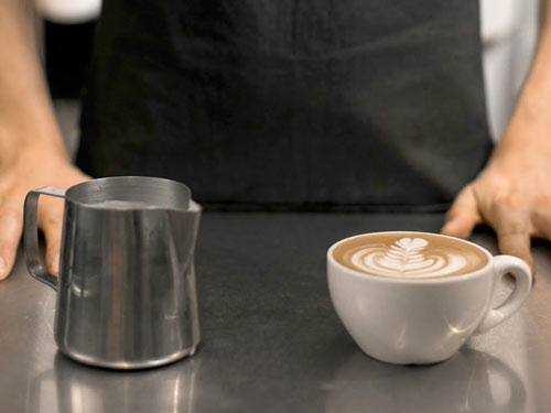 barista standing behind coffee