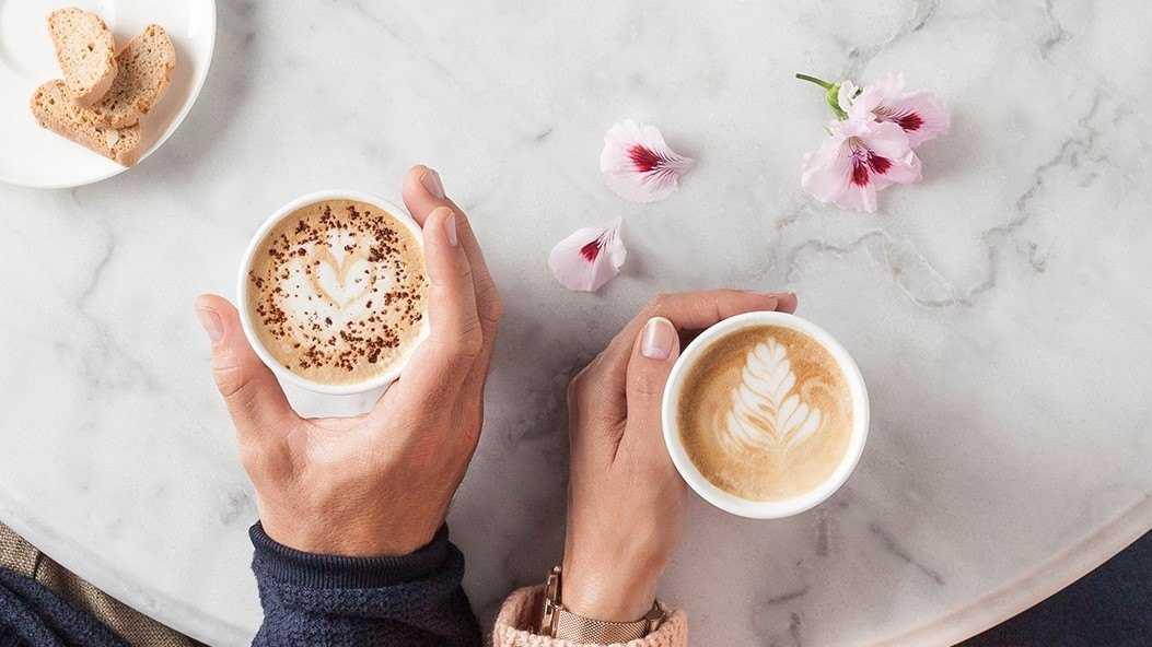 people holding coffees