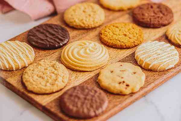 several flavoured border biscuits on a wooden platter