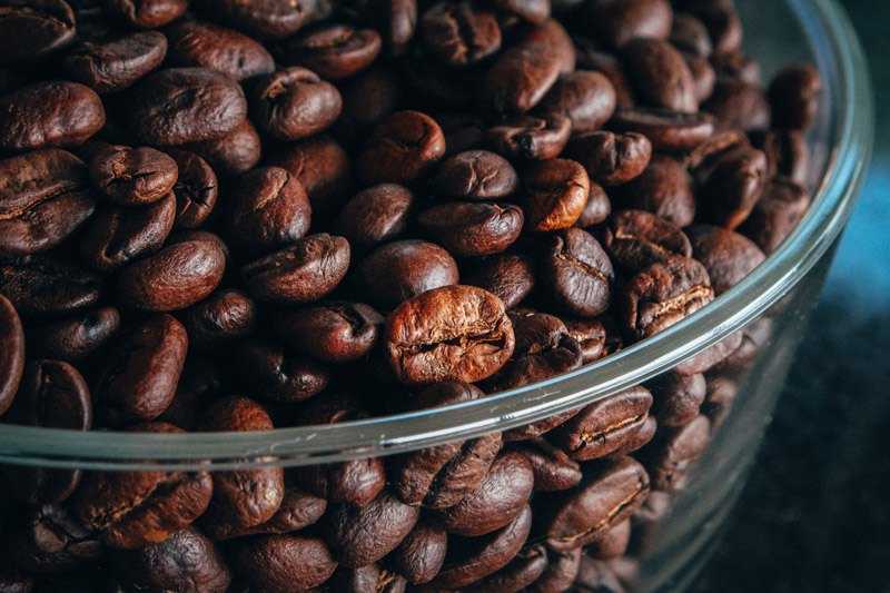 dark brown coffee beans in a bowl