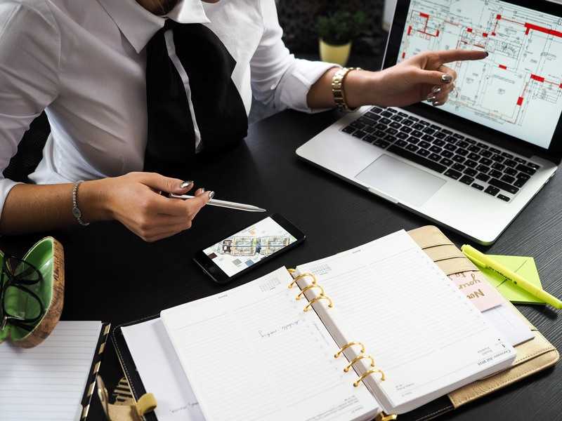 woman pointing to building plans on a screen