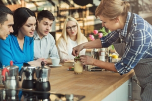 Experienced smiling barista giving master class