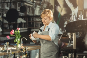 Portrait of experienced barista at coffee shop counter