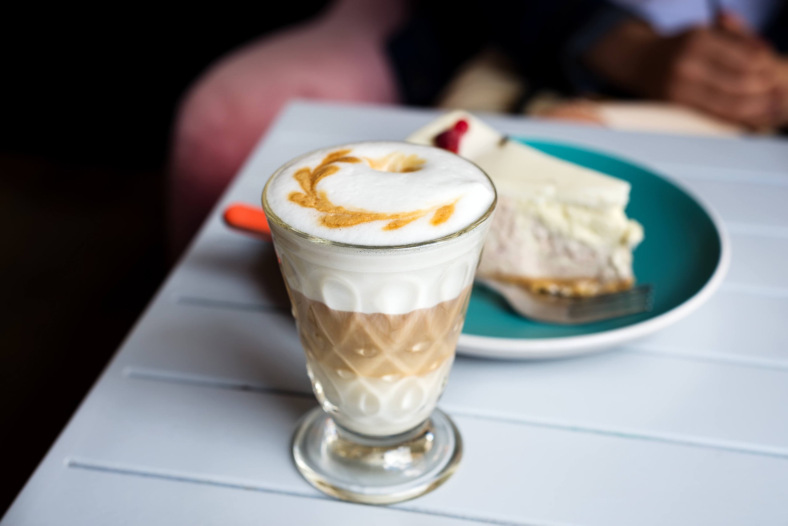 Glass of Latte macchiato with rich milk foam in cafe
