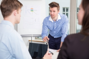 Businessman Communicating With Colleagues In Meeting at Office