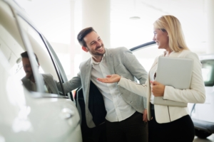 Portrait of happy customer buying new car Portrait of happy customer buying new car