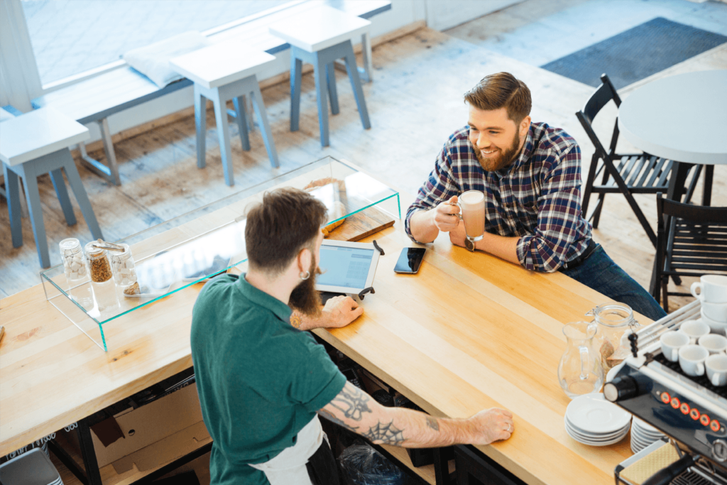 Barista chatting to a male customer