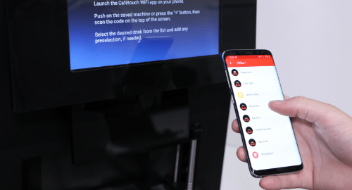 Person using smartphone app to control coffee machine