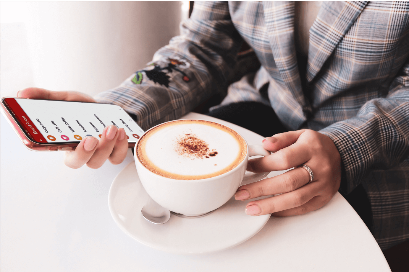 Person using touches coffee machine app on their phone